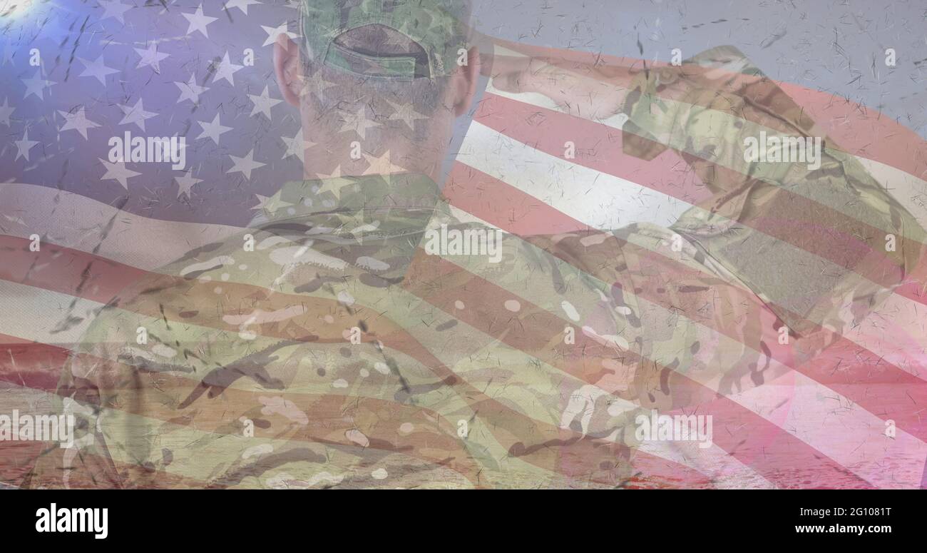 Composition of male soldier saluting over american flag Stock Photo - Alamy