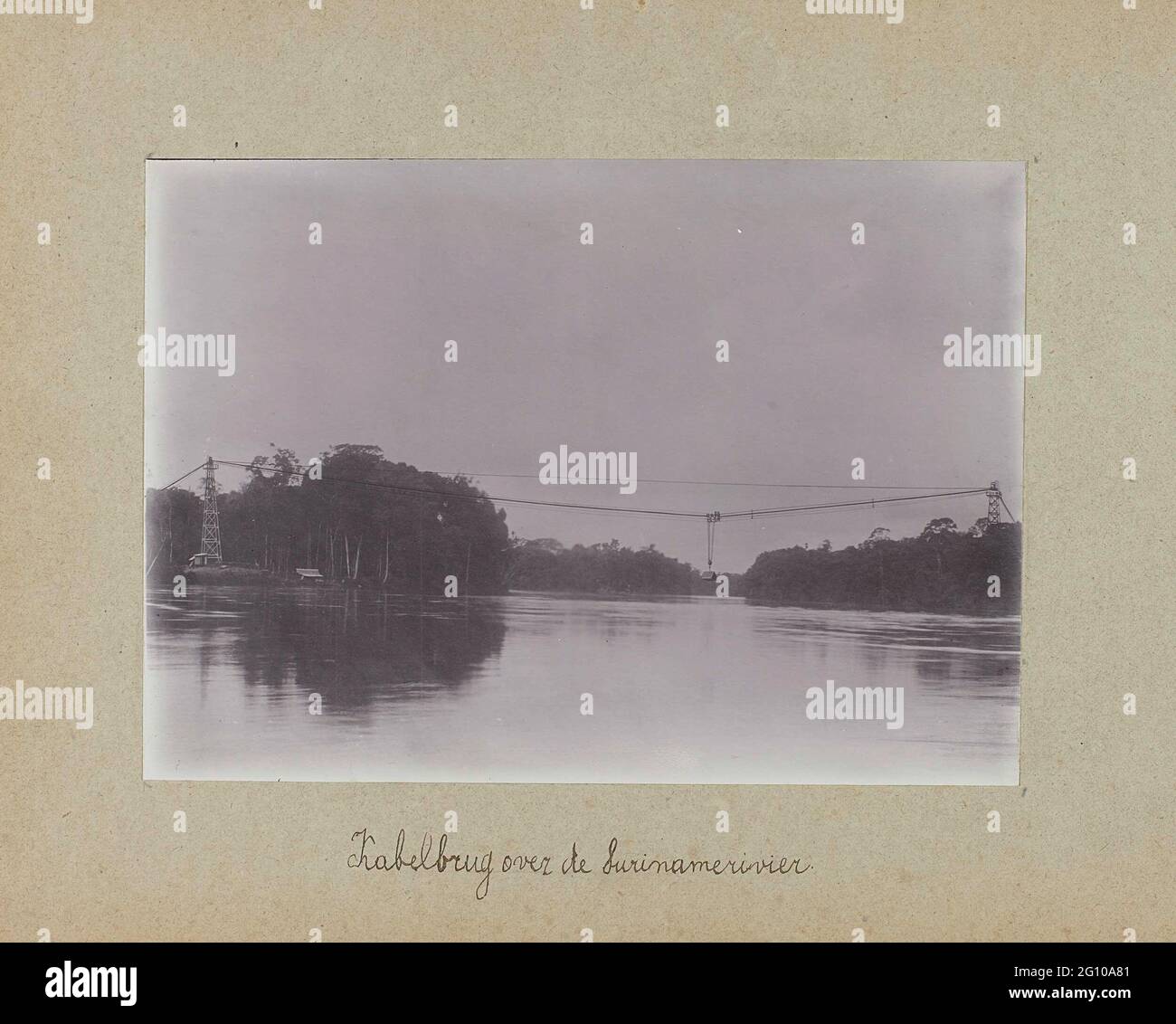 Cable bridge over the surinamer river. View of the cable bridge over the surinamer river. Photo in the photo album about the construction of the Lawaspoor road in Suriname in the years 1903-1912. Part of a group of objects from the Wesenhagen family in Suriname. Stock Photo