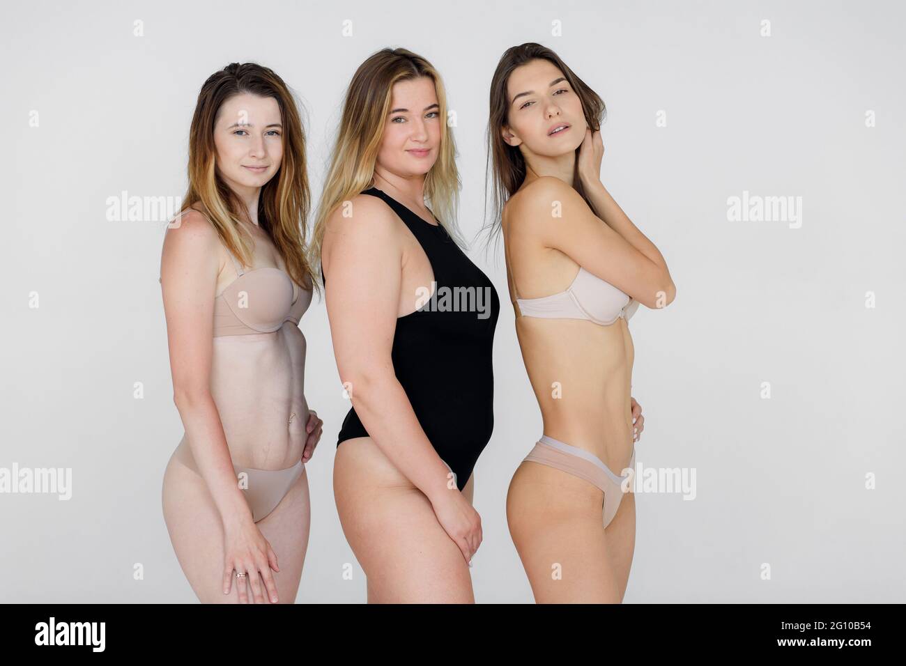 Group of women with different body and ethnicity posing together to show the woman power and strength. Curvy and skinny kind of female body concept Stock Photo