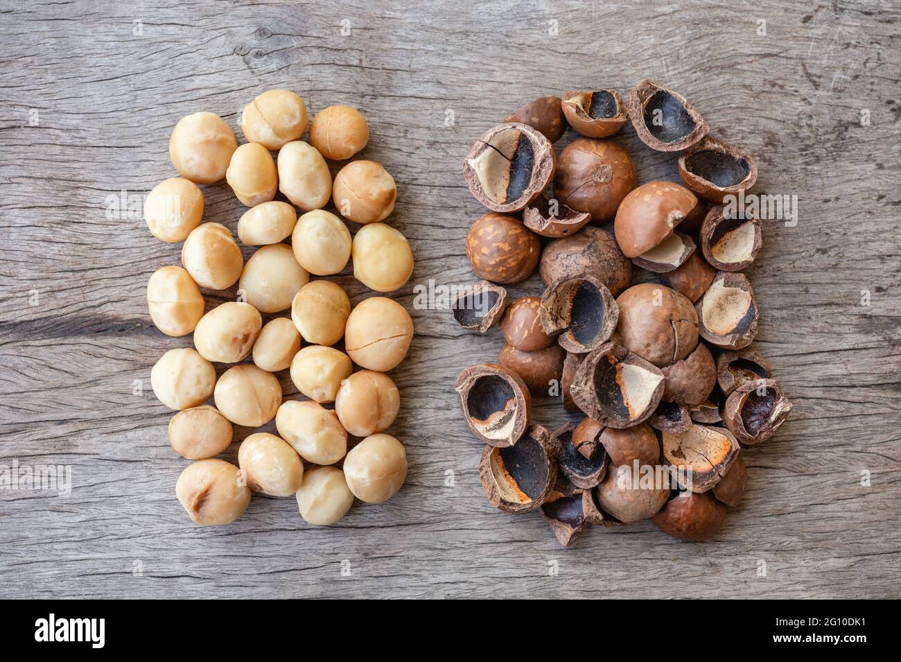 Organic Macadamia nuts and shell on wooden table Stock Photo