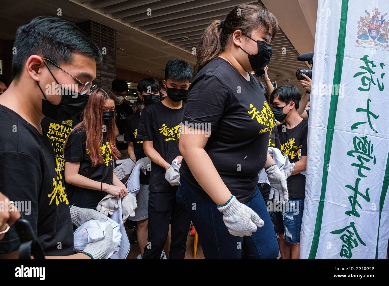 Hong Kong, China. 04th June, 2021. Members of Hong Kong University Students' Union gather to commemorate the June Fourth Incident. The annual ritual of washing the Pillar of Shame, a sculpture located on the University of Hong Kong campus that commemorates the victims of the 1989 Tiananmen Square crackdown in Beijing, was held as Hong Kong remembers June 4 for the first time since Beijing imposed a national security law on the city. Credit: SOPA Images Limited/Alamy Live News Stock Photo