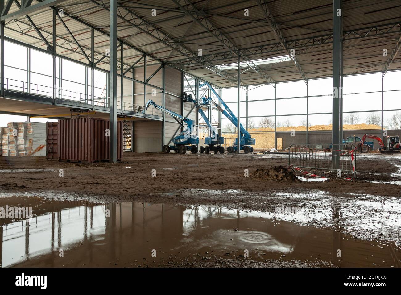 VENLO, NETHERLANDS - Feb 01, 2018: Multiple aerial platforms in a warehouse that is under construction. Stock Photo