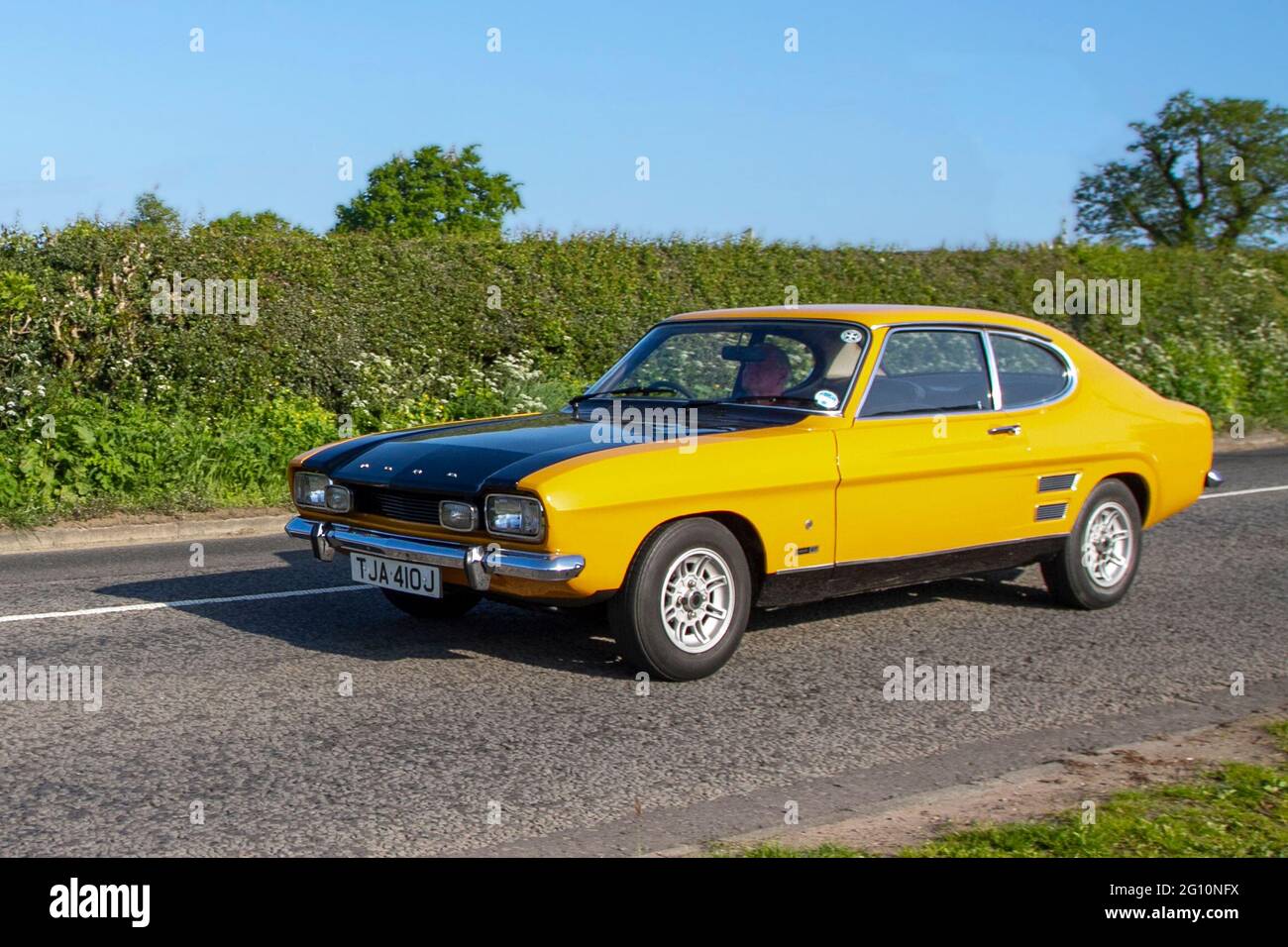 1971 70s seventies yellow black Ford Capri 1600 GT, 1598cc petrol en-route to Capesthorne Hall classic May car show, Cheshire, UK Stock Photo