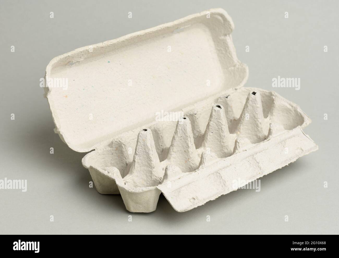 blank paper rectangular tray for chicken eggs on a gray background, close up Stock Photo