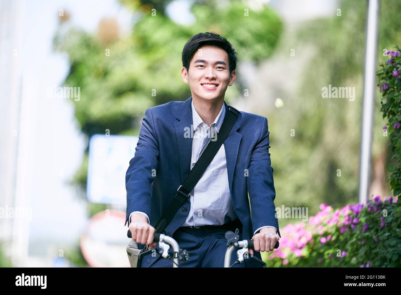 young asian business executive commuting by bike happy and smiling Stock Photo