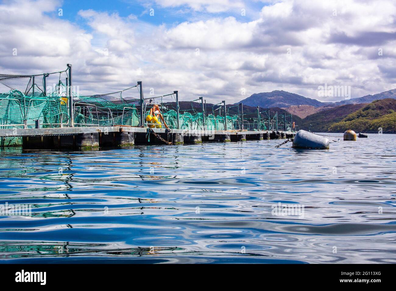 A fish farm on a sea loch on the North West coast of Scotland Stock Photo