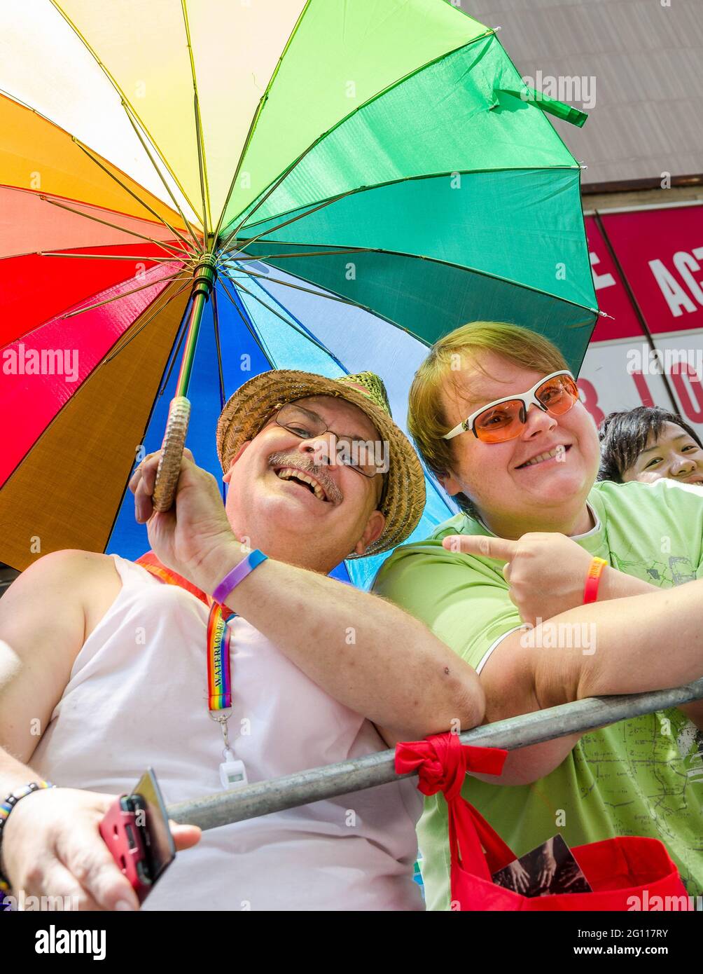 Couple in the public watching and having fun during the 32nd edition of the Pride Parade. Stock Photo