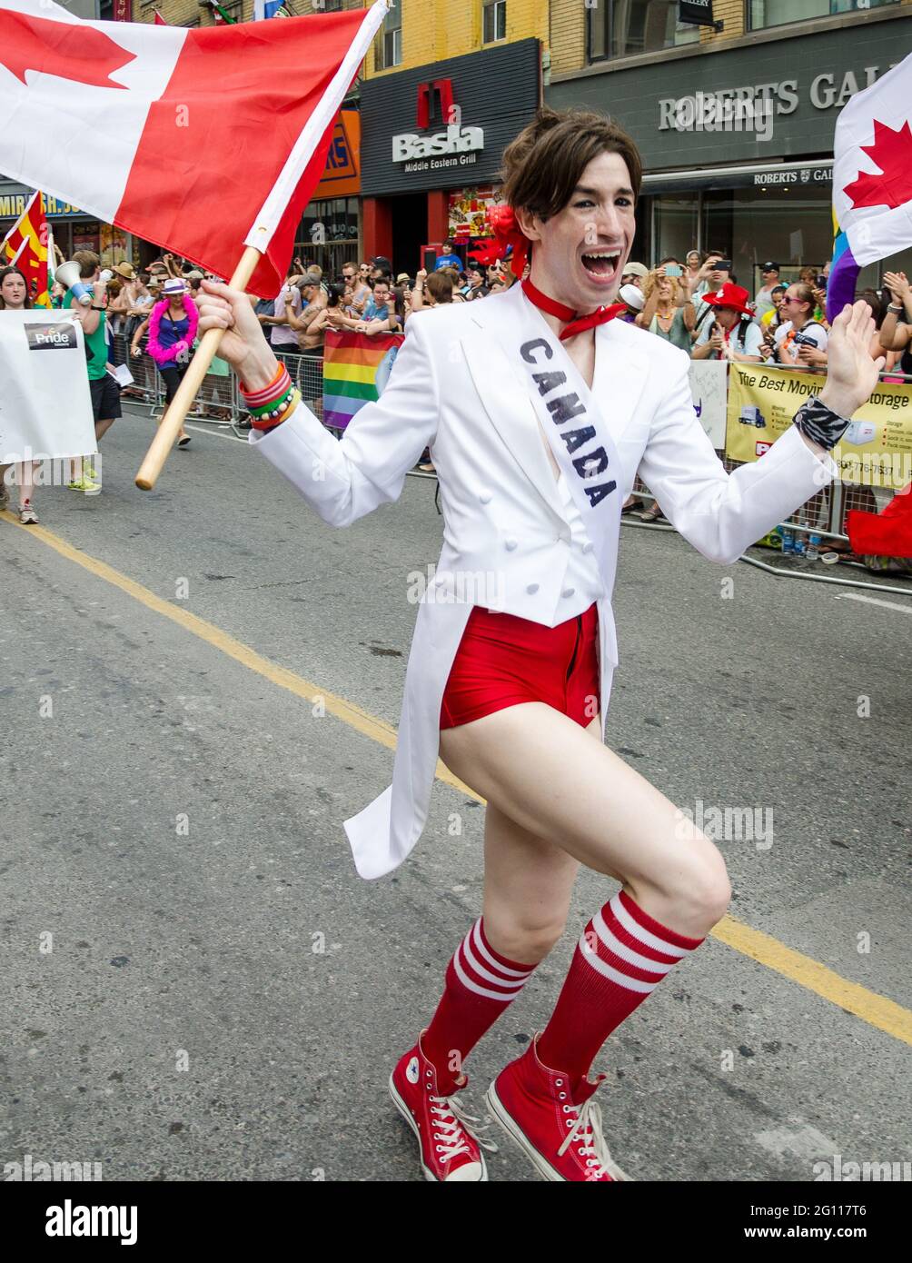 Happy person wearing Canada's colors and marching during the 33rd Pride Parade which celebrates the history, courage, diversity and future of the Lesb Stock Photo