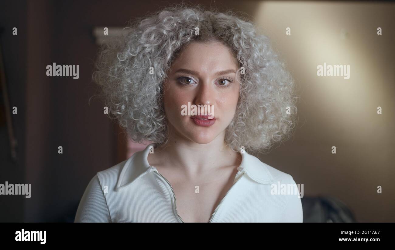 Portrait of beautiful woman with curly white-hair. Stock Photo