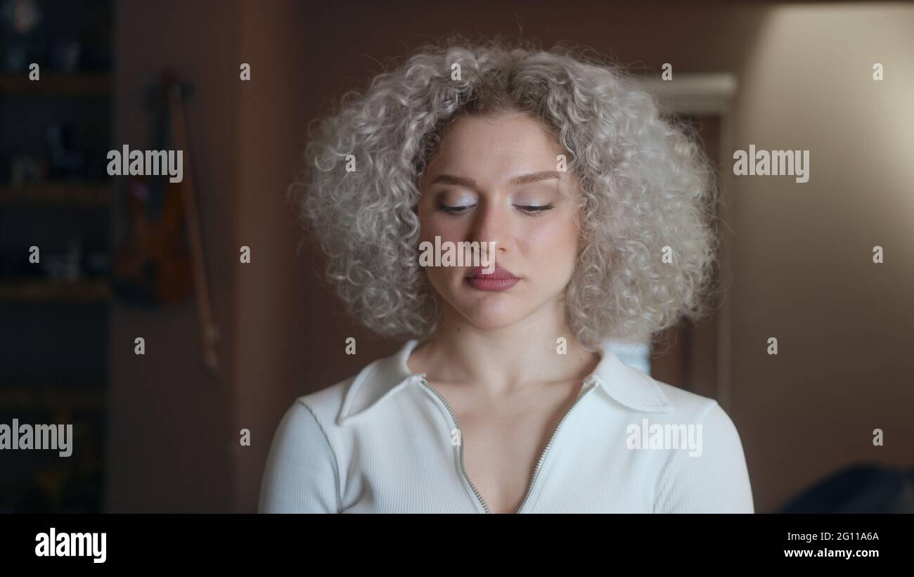 Portrait of strong feminist woman with curly white-hair. Stock Photo
