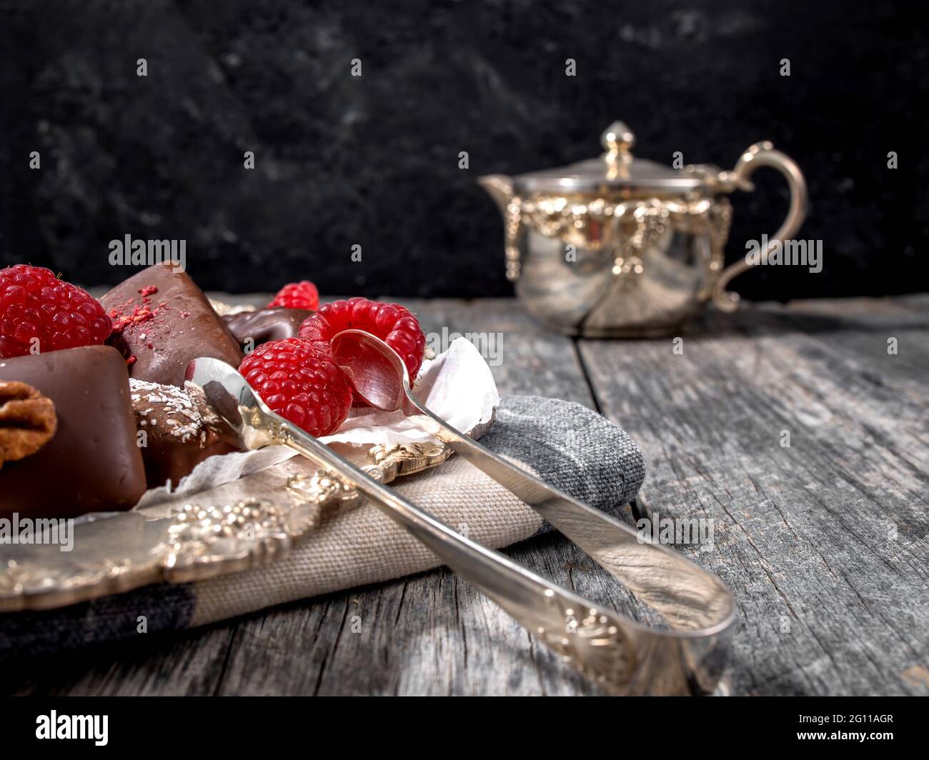 Dark handmade chocolate stack with raspberries and nuts Stock Photo - Alamy