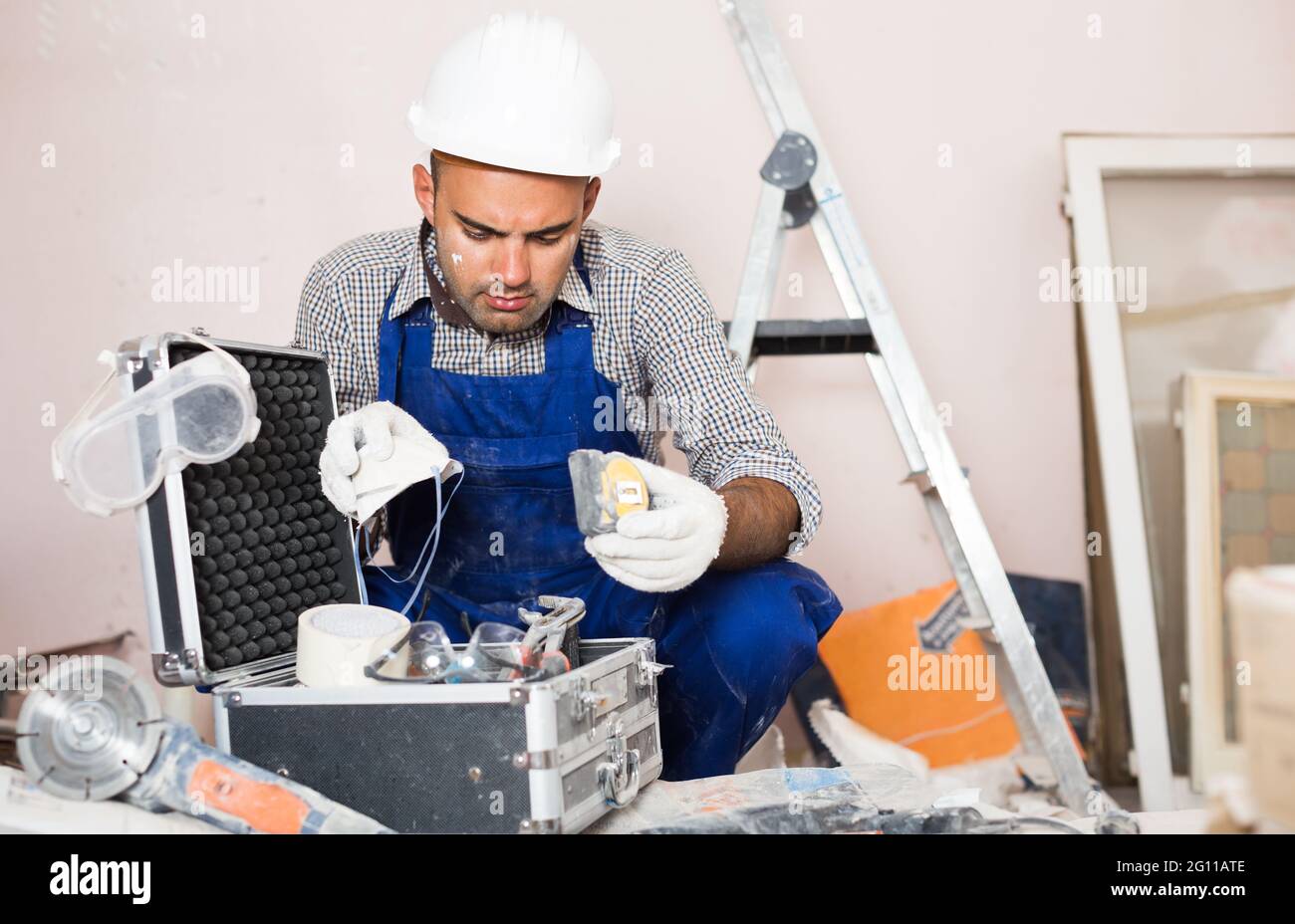 worker builder is carefully looking Stock Photo