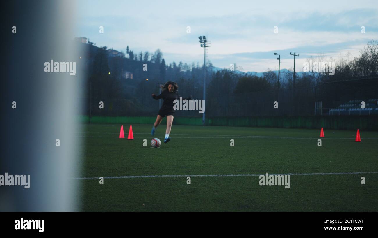 Woman Soccer Player Kicking Ball Into Goal From Penalty Marker View From Back Of The Goal Stock Photo Alamy