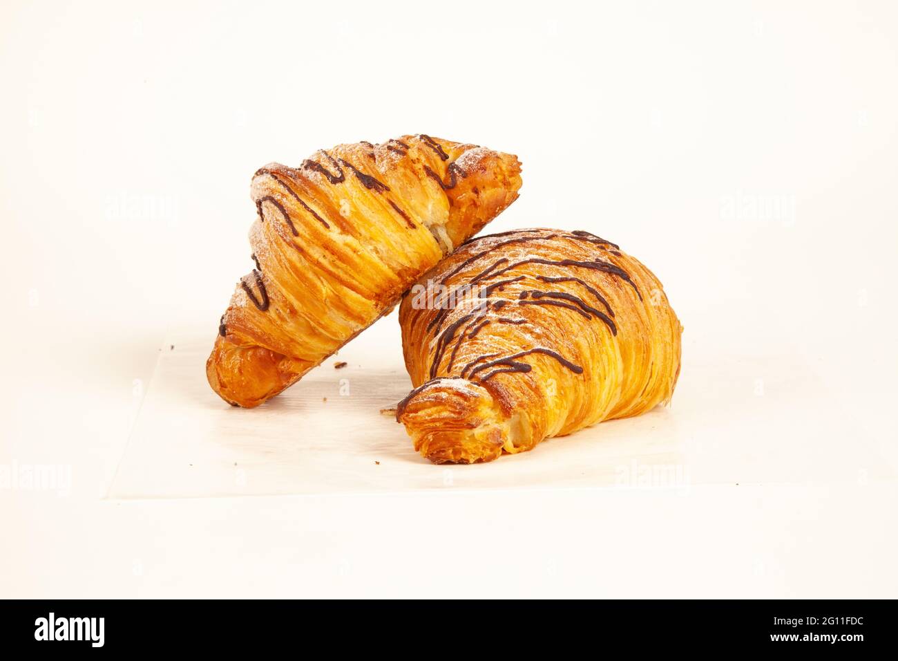 Chocolate filled brioche croissant flaky made in butter isolated on white background Stock Photo