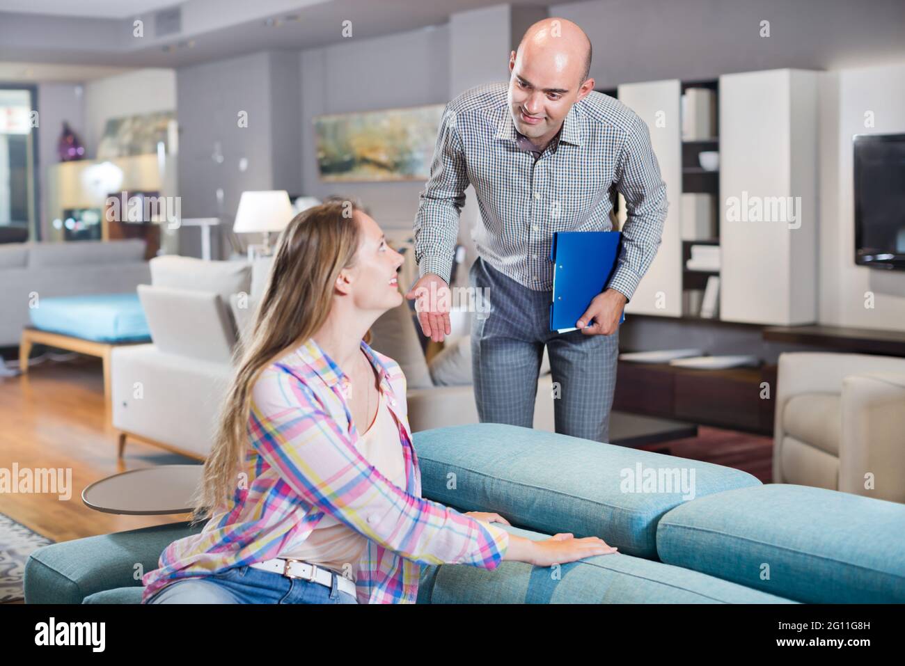 Woman choosing furniture for apartment Stock Photo Alamy