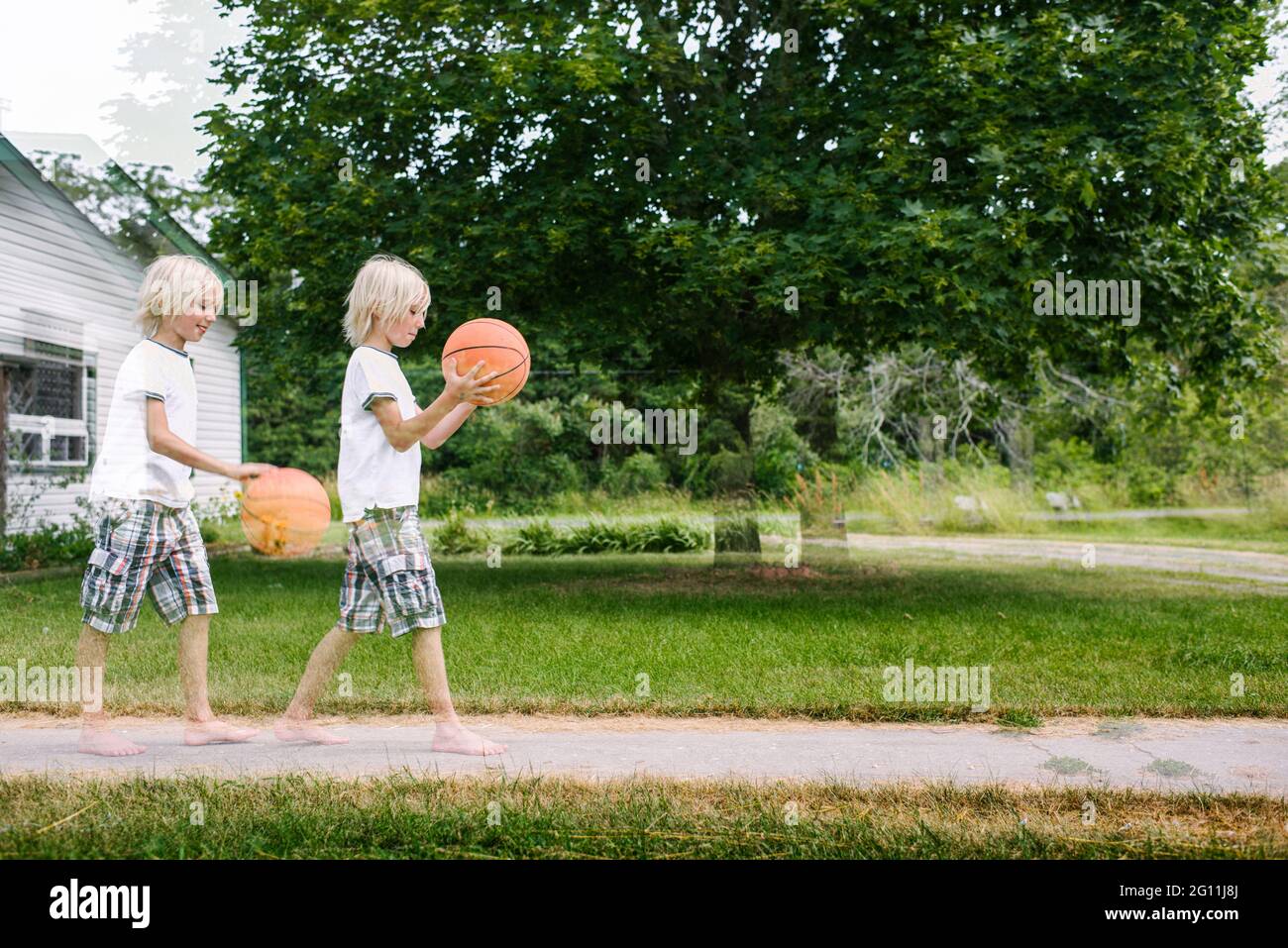 Canada, Ontario, Multiple exposure of boy with basketball ball outdoors Stock Photo