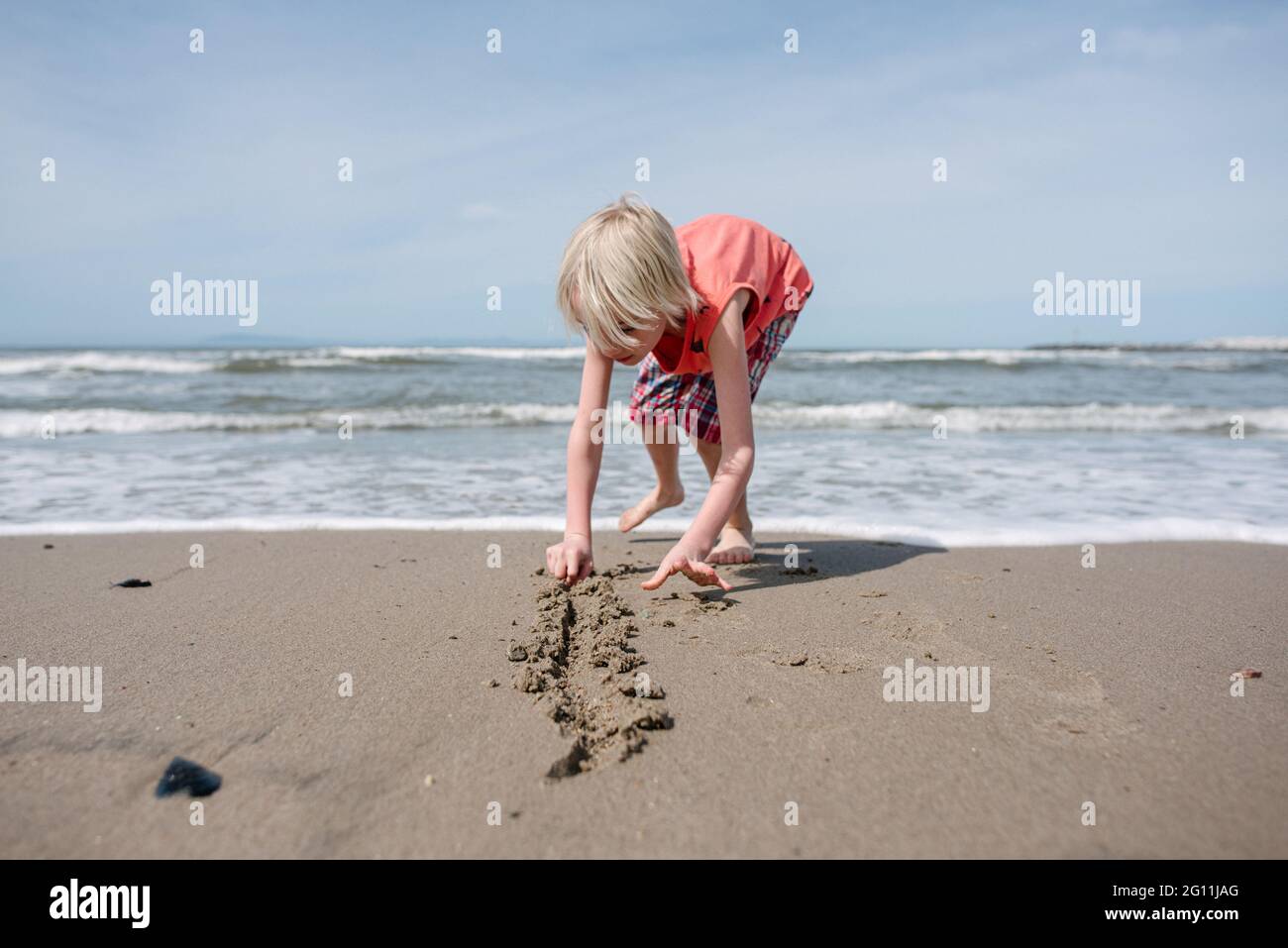 USA, California, Ventura, Boy playing on beach Stock Photo