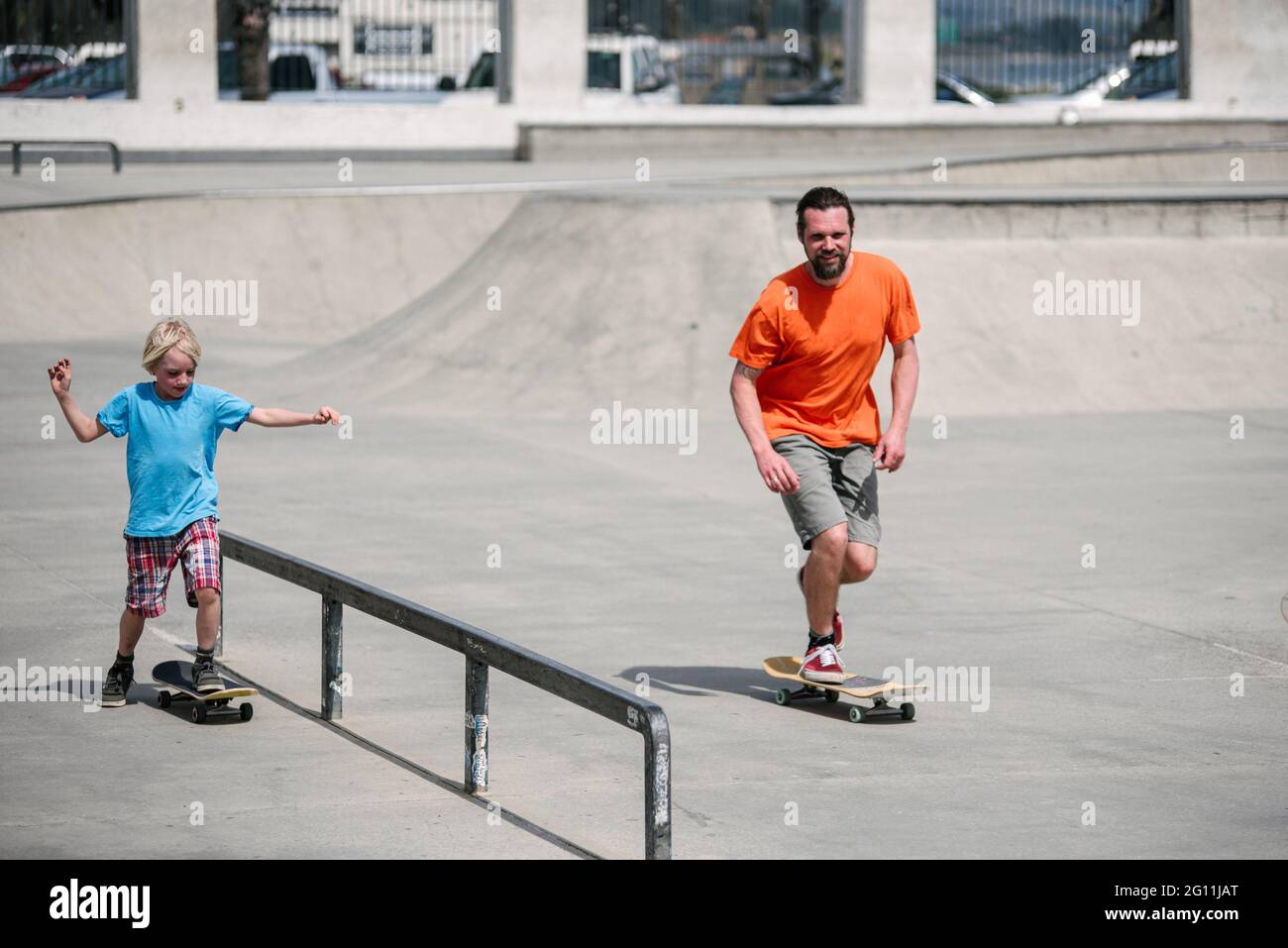 USA, California, Ventura, Father and son skateboarding in skate park Stock Photo