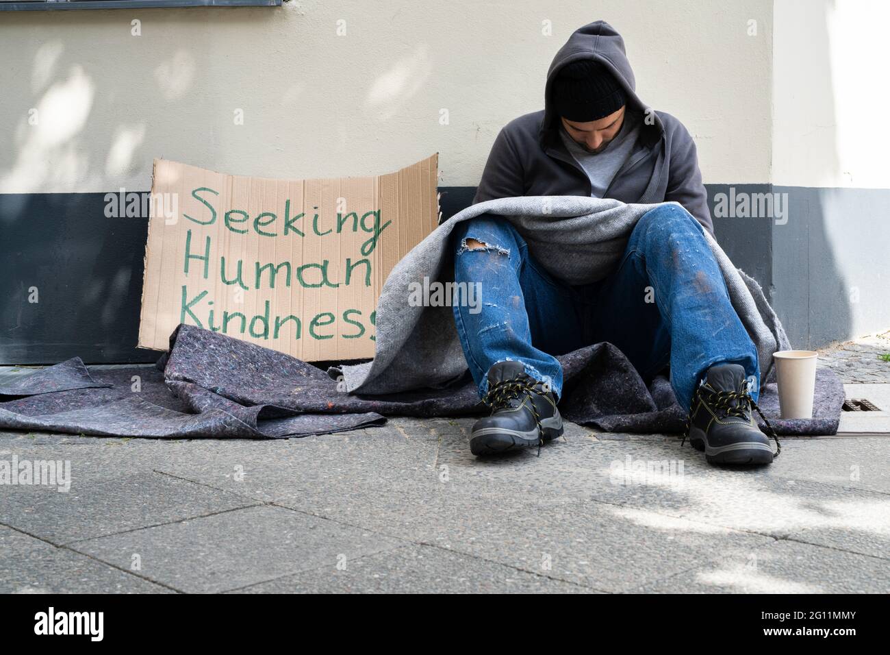 Homeless Lonely Poor Man With Cardboard Seeking Kindness Stock Photo