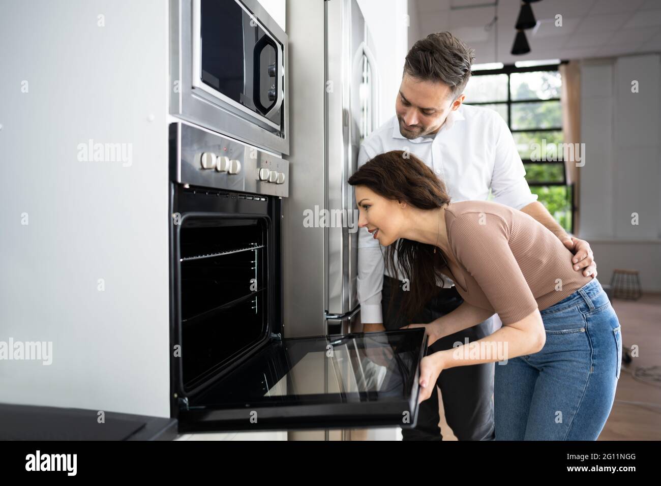 Couple Buying Electrical Oven With Consumer Loan Credit Stock Photo