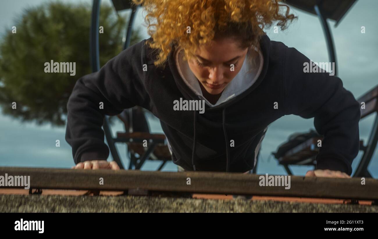 Strong woman doing push ups workout close-up. Stock Photo