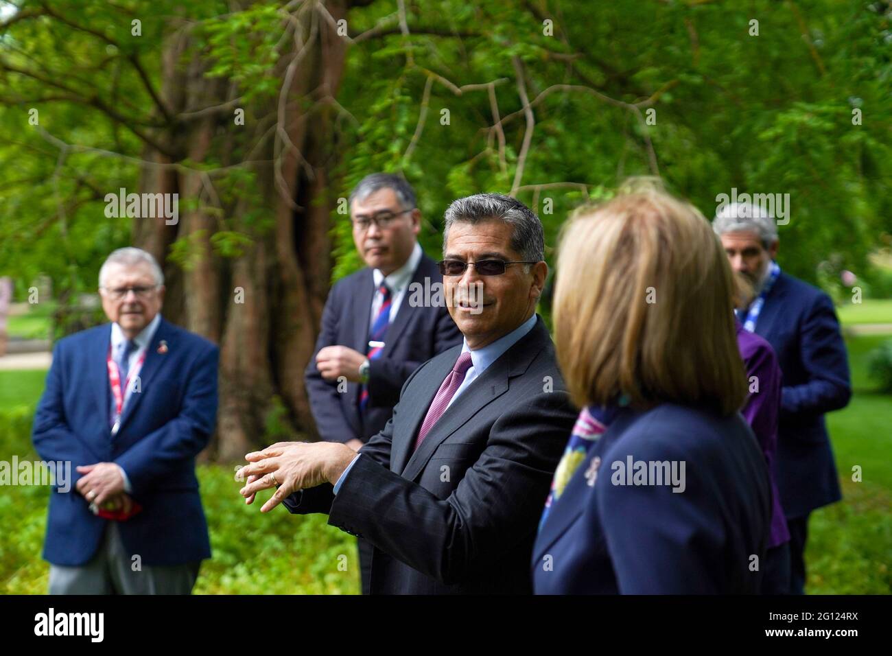 America's Secretary of State for Health Xavier Becerra (centre) takes part  in a memorial tree planting ceremony at Oxford Botanic Gardens following  their meeting at Mansfield College, Oxford University, ahead of the