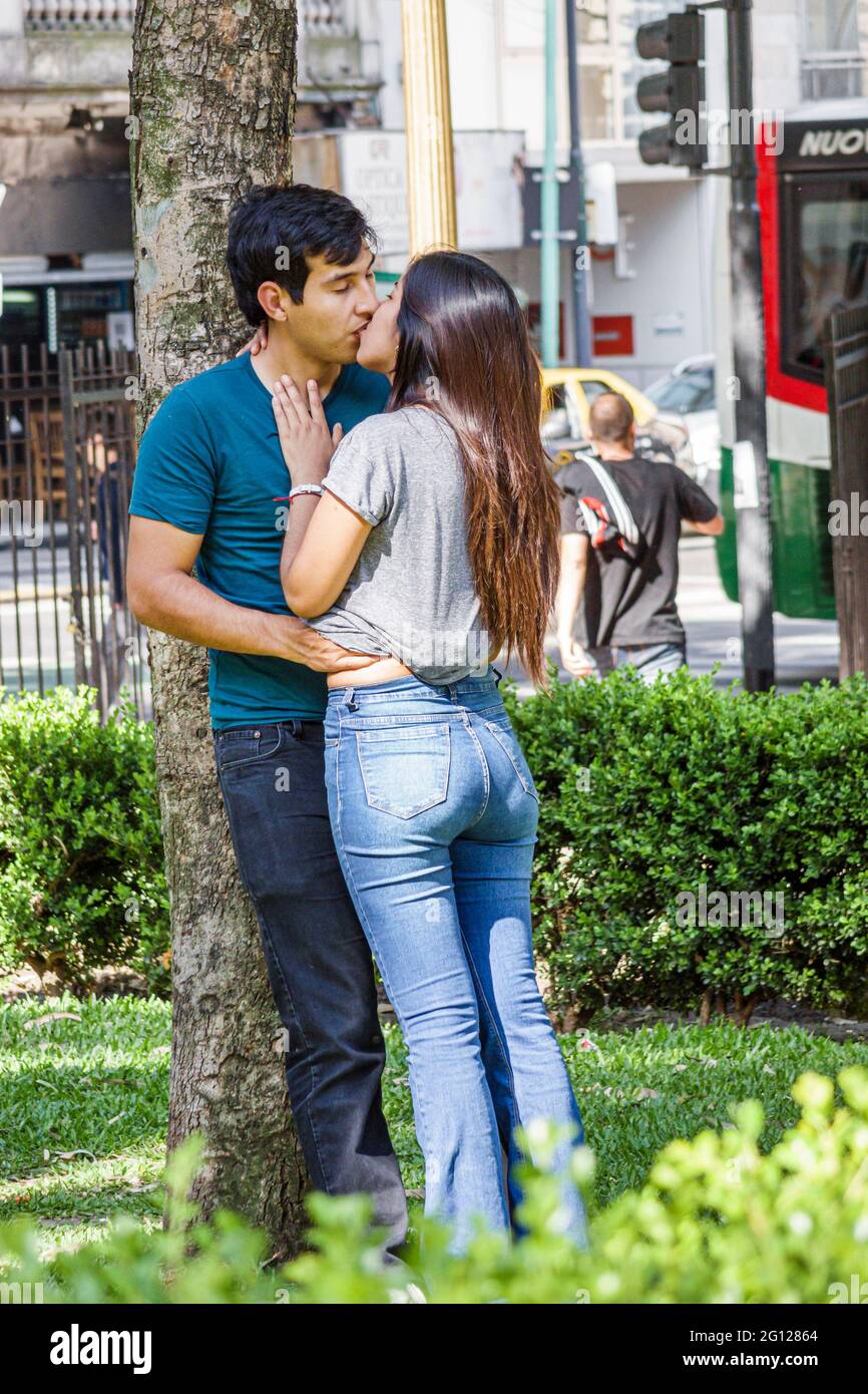 Argentina Buenos Aires Plaza Lavalle Square urban park green space Hispanic boy girl teen couple romance kissing kiss passion sexuality Stock Photo