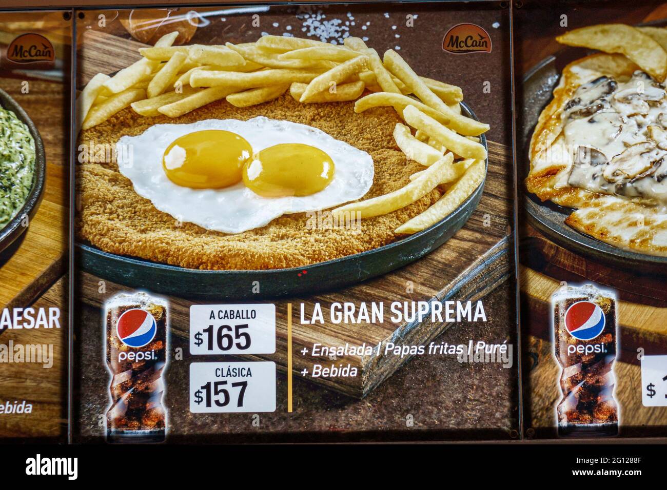 Argentina Buenos Aires restaurant photo menu typical food Pepsi marketing Spanish language fried food eggs French fries Milanesa a Caballo chicken fri Stock Photo
