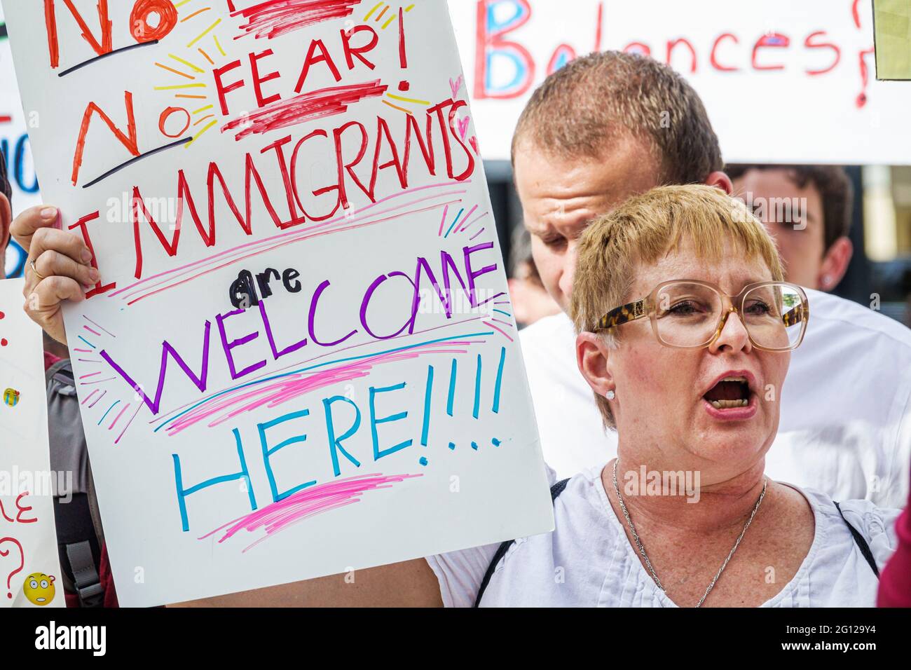 Florida Miami downtown Keep Families Together Protest anti-Trump immigration family child separation policy activist protester woman holding sign pro Stock Photo