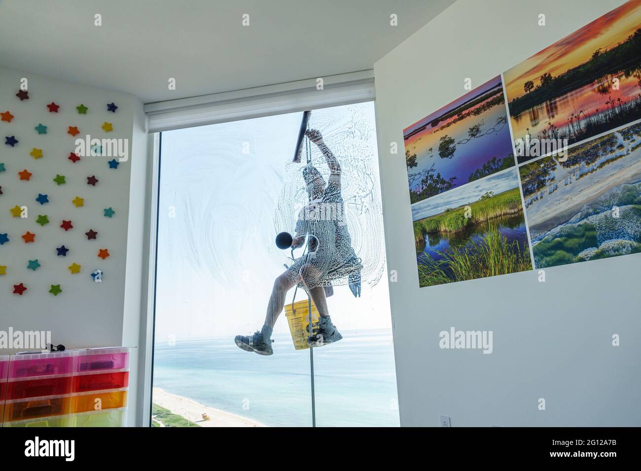Florida FL Miami Beach high rise condominium man glass window washer