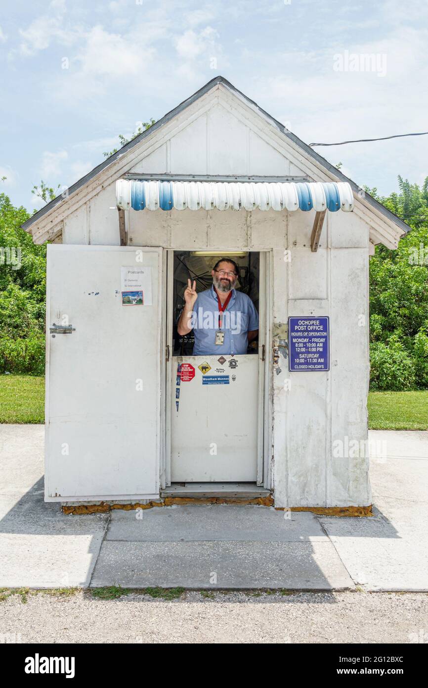 Florida FL South Everglades Ochopee Tamiami Trail US highway Route 41 smallest US Post Office 34141 building landmark man mailman postal clerk Stock Photo