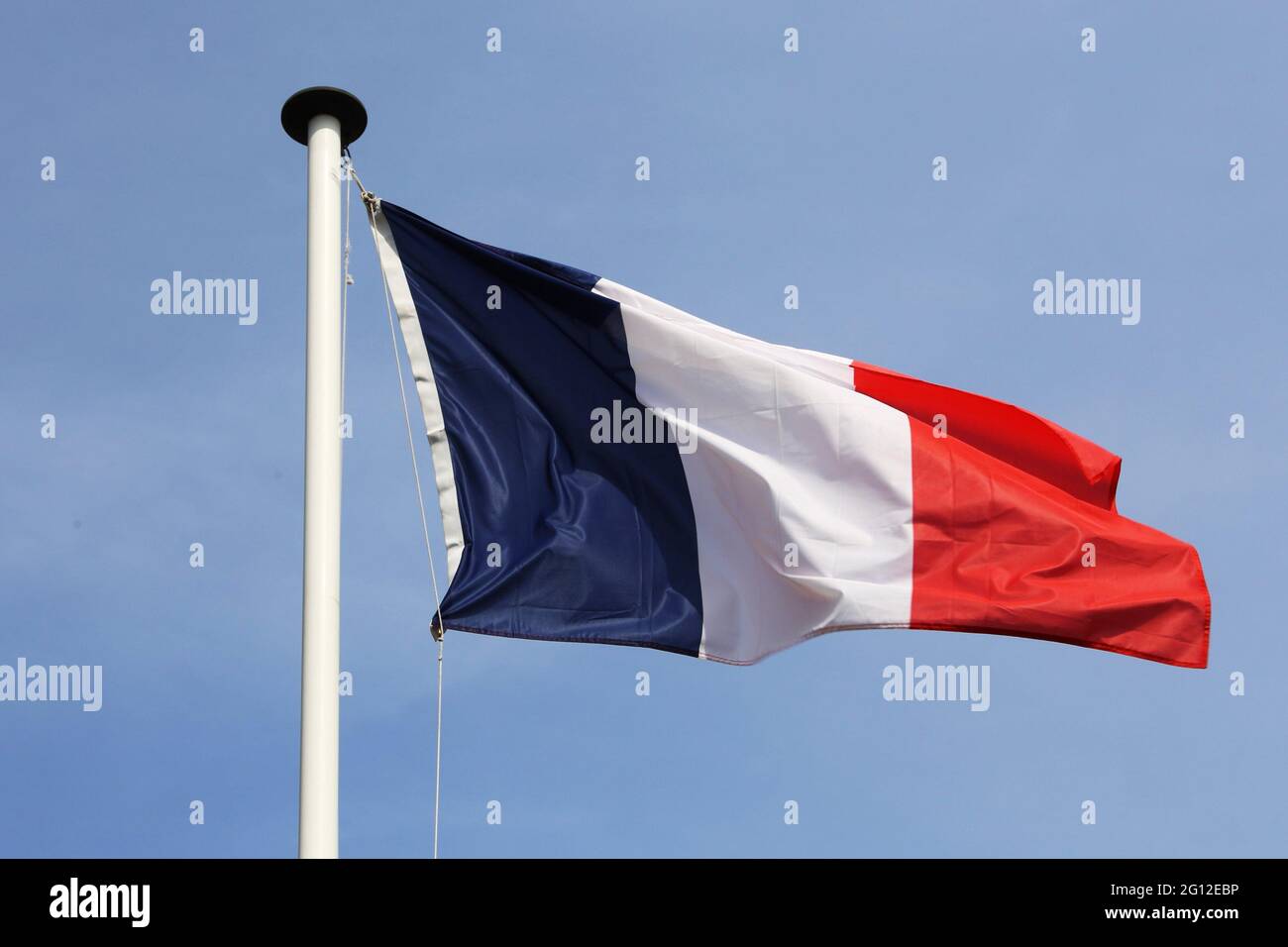 French flag in front of a blue sky. Stock Photo