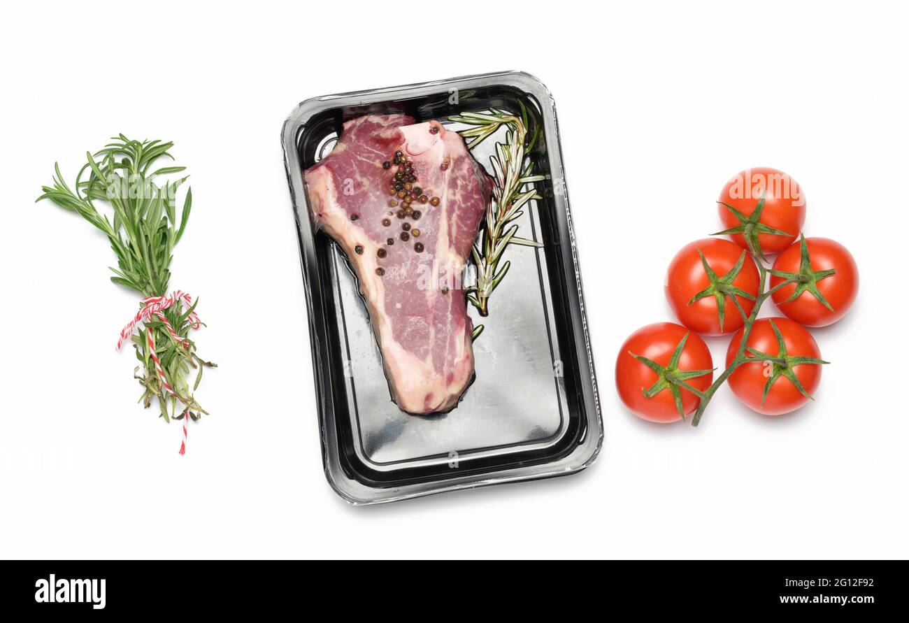 Raw New York beef steak is packed in a plastic container and vacuum