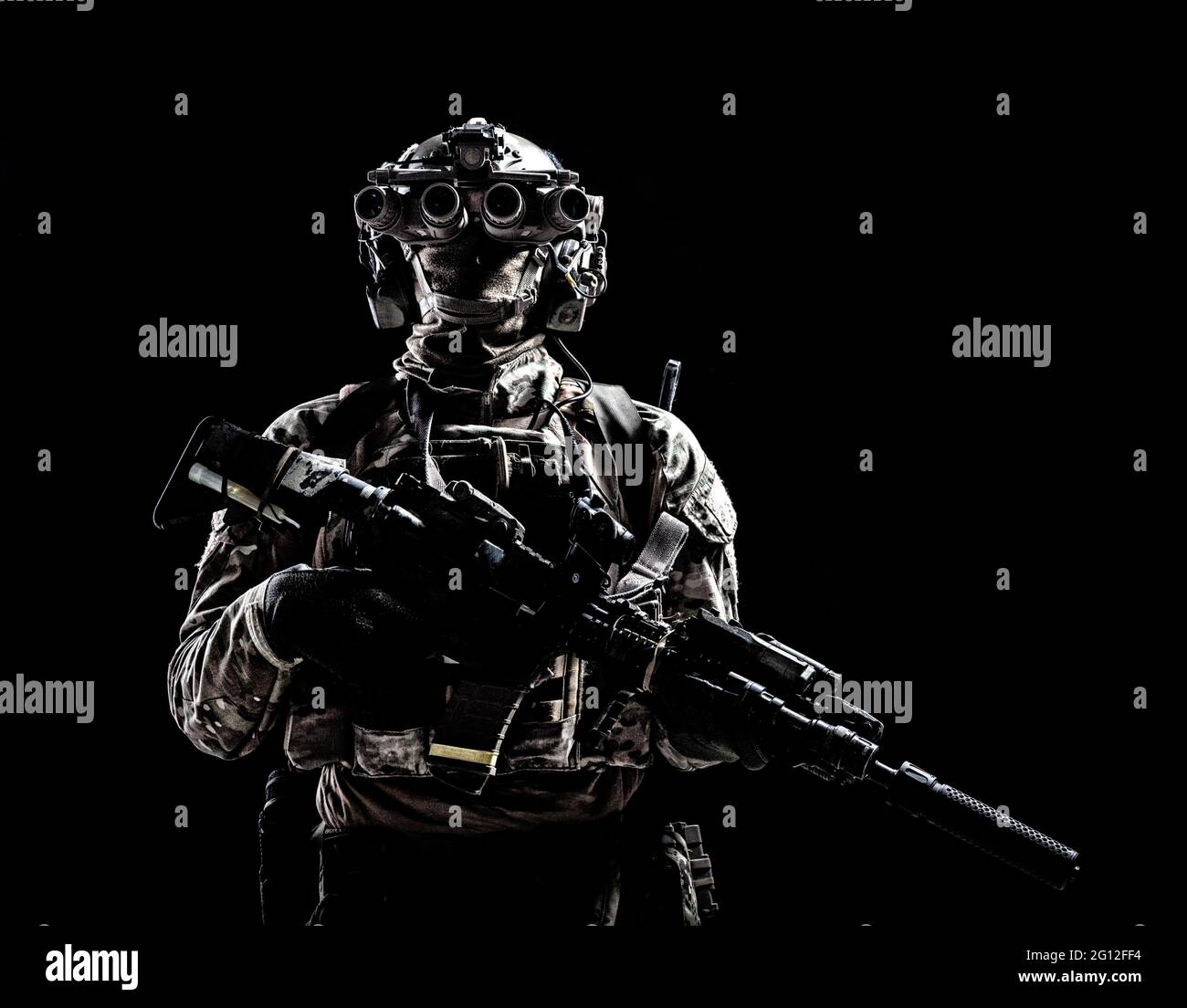 Modern army special forces equipped soldier, anti terrorist squad fighter, elite mercenary armed assault rifle, standing in darkness with night Stock Photo