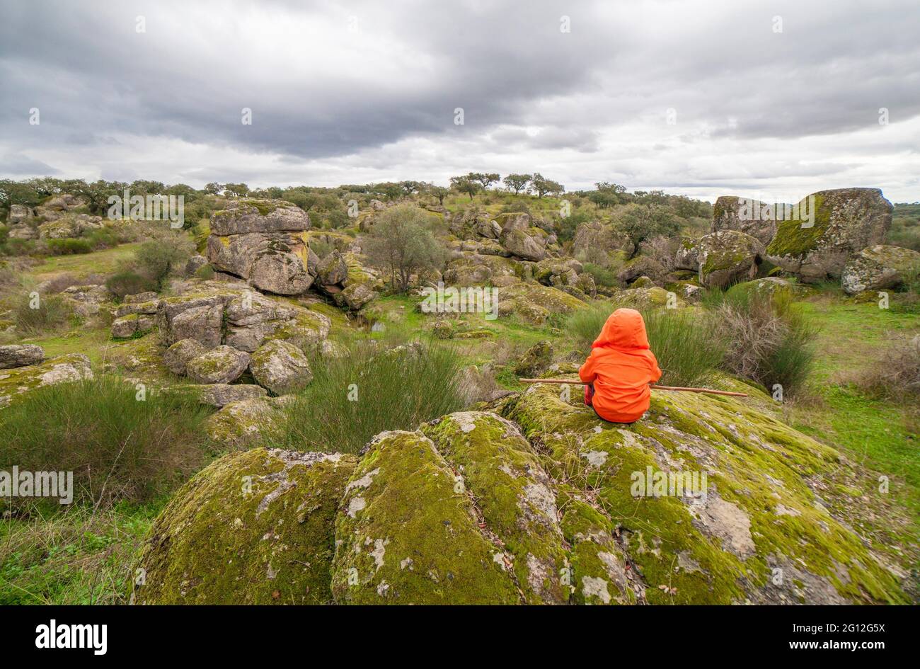 Child boy observing spectacular granitic landscape of Cornalvo Natural Park, Extremadura, Spain. Stock Photo