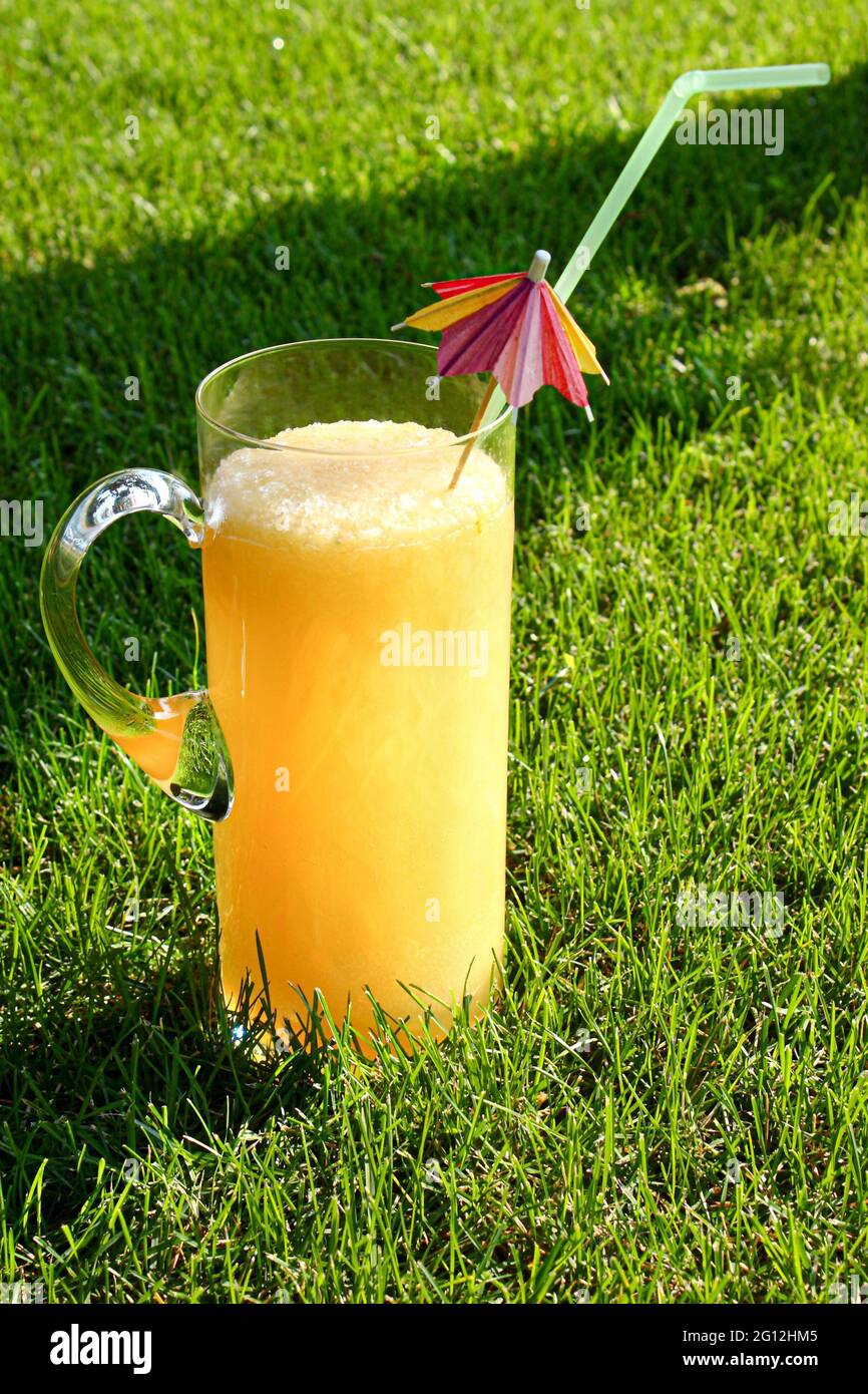Lemonade jug on the green grass of the lawn Stock Photo Alamy