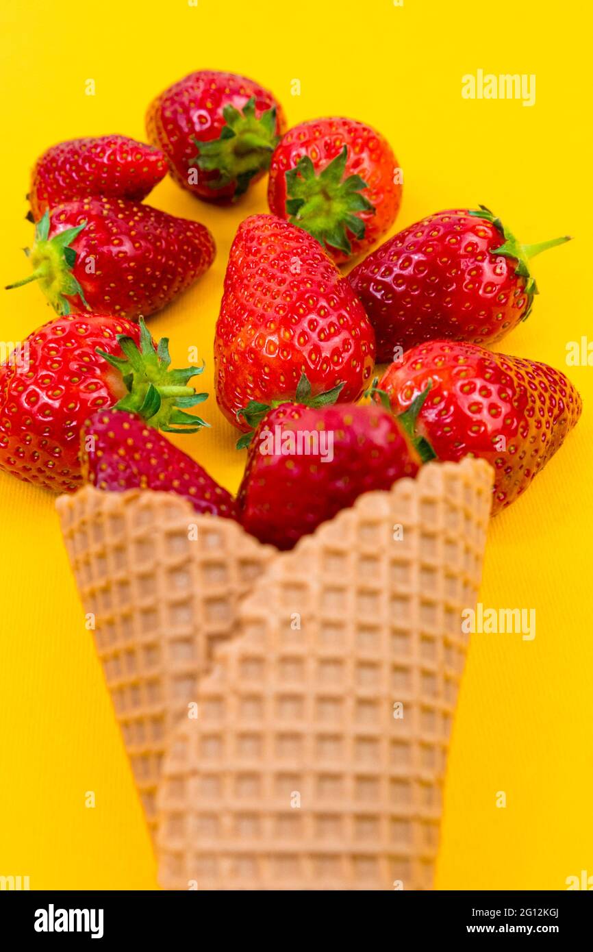 Ice cream cone with strawberries. Strawberry icecream. Healthy summer food concept. Stock Photo