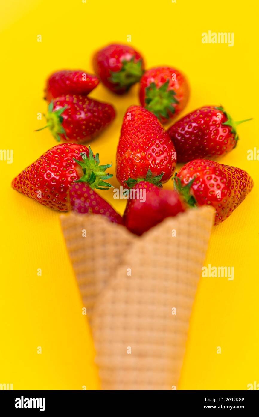 Ice cream cone with strawberries. Strawberry icecream. Healthy summer food concept. Stock Photo