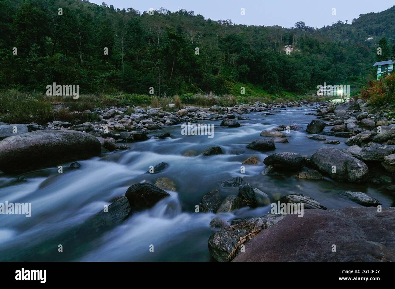 Reshi River water flowing on rocks at dusk,  Sikkim, India Stock Photo