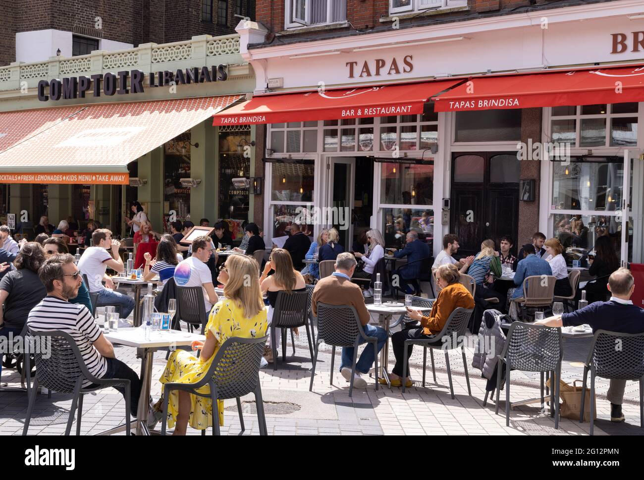London lifestyle; people sitting outdoors at Tapas Brindisa restaurant in summer sunshine, South Kensington, London city centre, London UK Stock Photo