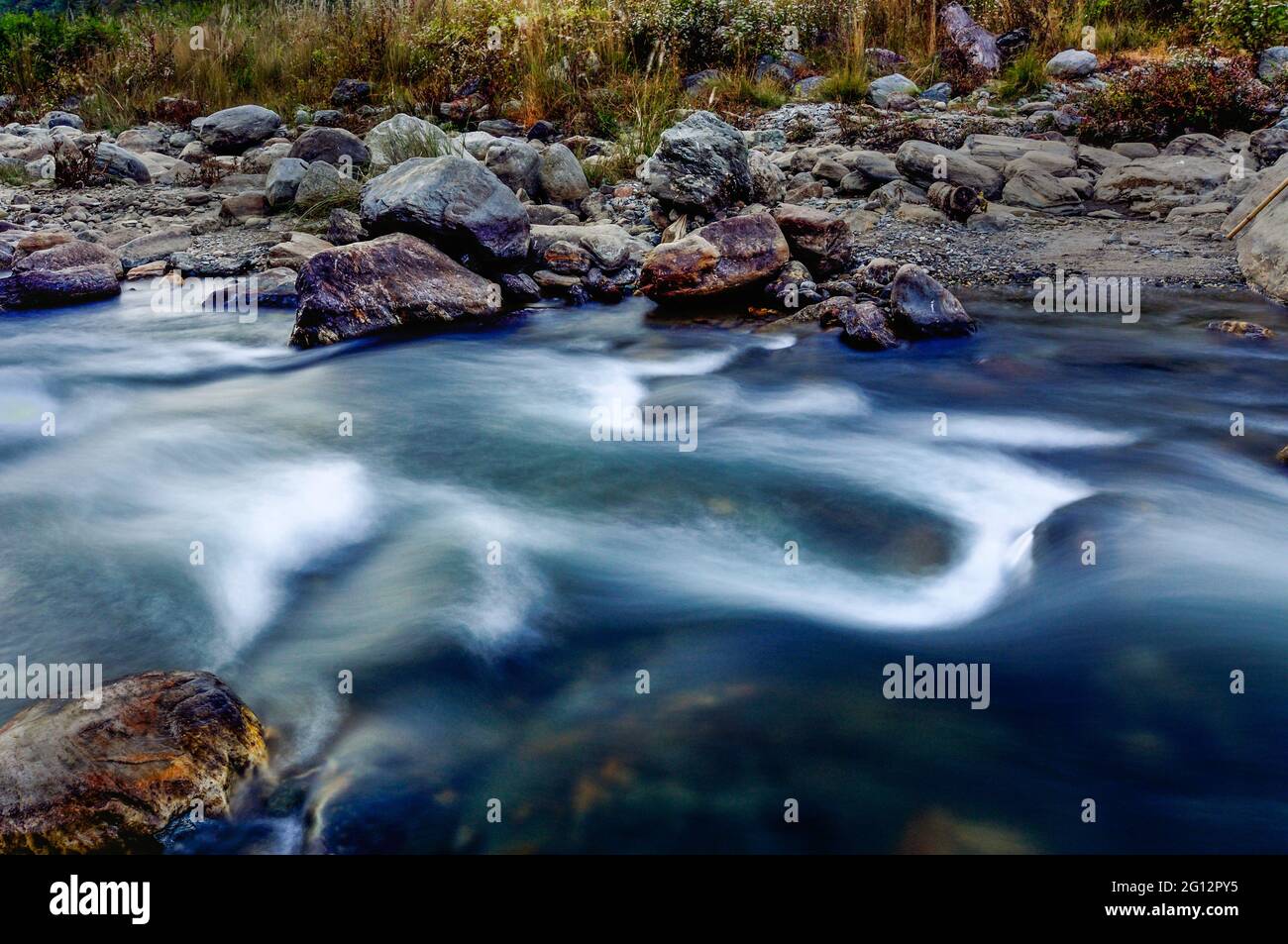 Reshi River water flowing on rocks at dusk,  Sikkim, India. Stock Photo