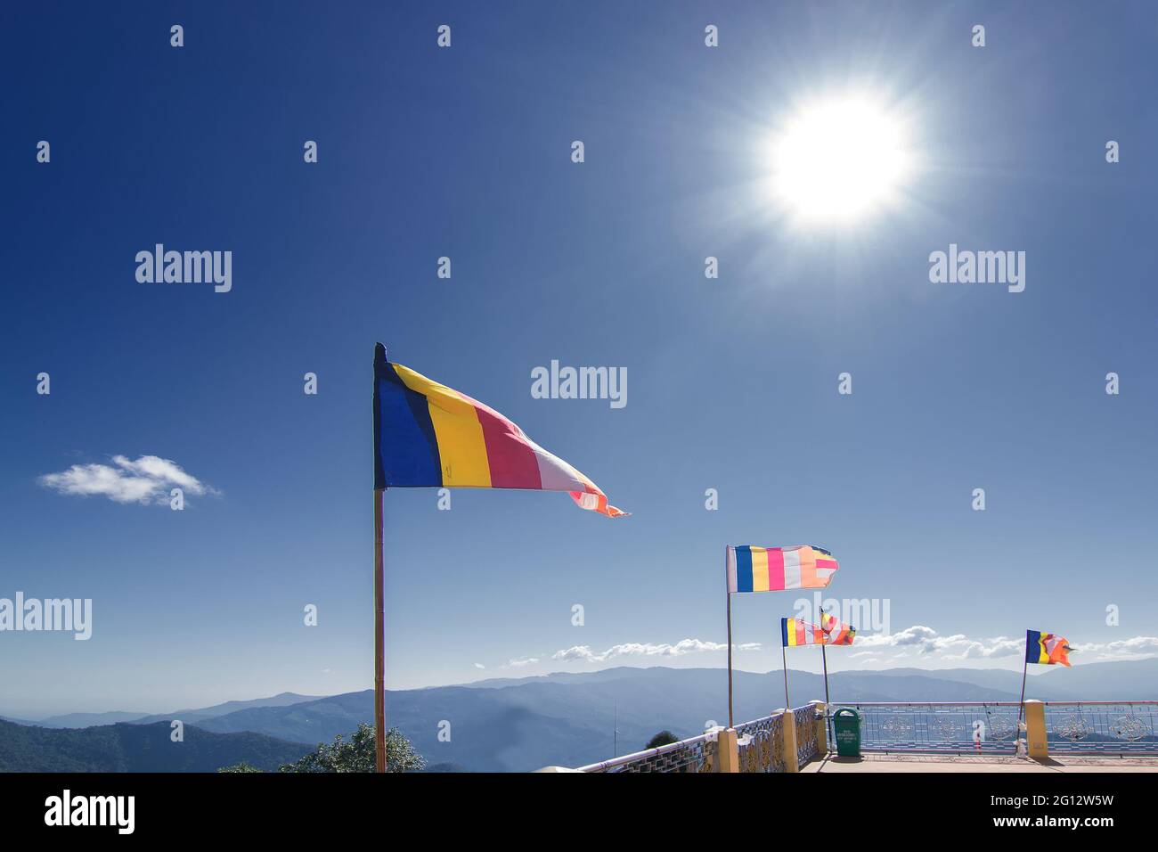 Courful Buddhist Prayer flags are waving in strong wind under sunshine at Samdruptse, huge buddhist memorial Monastery in Sikkim, India. Stock Photo