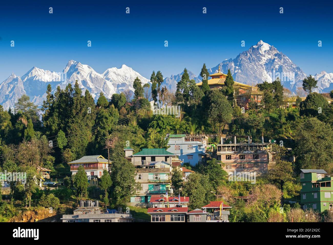 Mount Pandim (right), Mount North kabru (middle) and Mount South Kabru (left) Himalayan Mountain range - with top of Rinchenpong town in foreground. Stock Photo