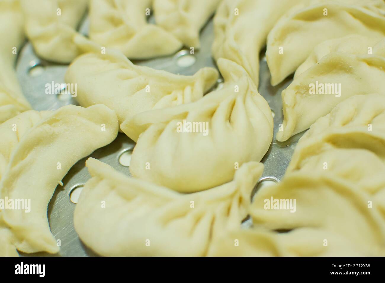 Momo , type of South Asian dumpling; native to Tibet, Nepal, Bhutan and Sikkim. It is similar to Chinese baozi and jiaozi, Mongolian buuz, Japanese gy Stock Photo