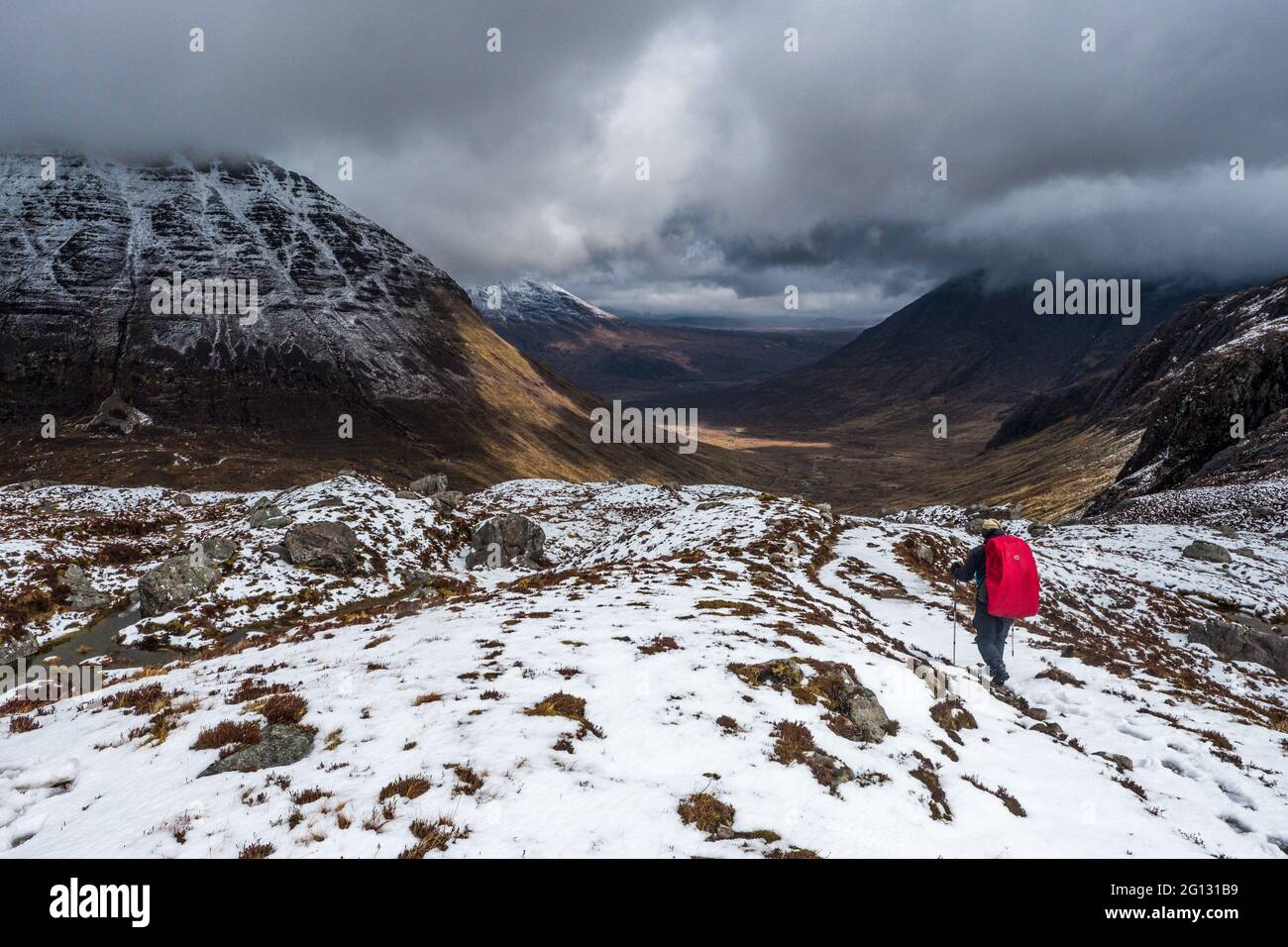 A backpacker with rucksack in the North West Highlands of Scotland Stock Photo