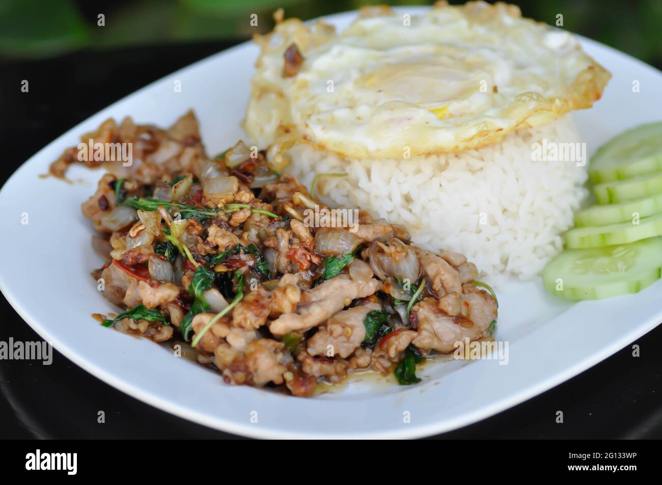 stir fried pork with holy basil , sunny side up egg and rice or Thai food Stock Photo