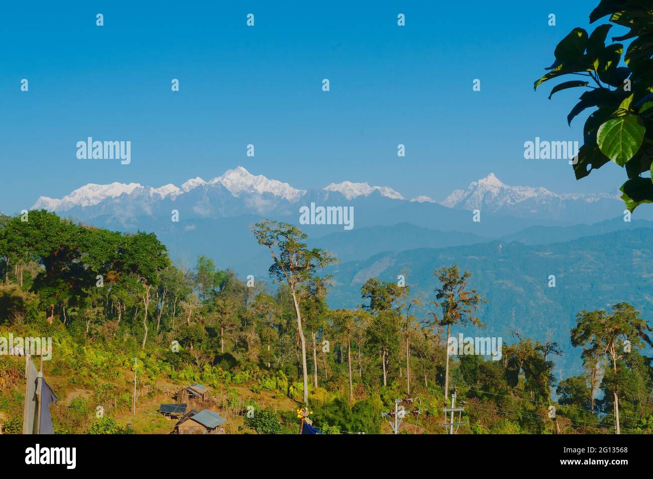 Beautiful view of Silerygaon Village with Kanchenjunga mountain range at the background, moring light, at Sikkim, India Stock Photo