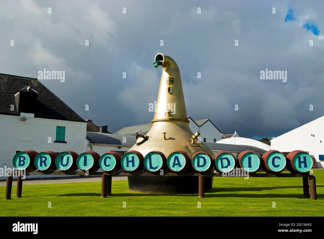 A view of the Bruichladdich Whisky Distillery barrel sign with the old pot still in the background. Stock Photo