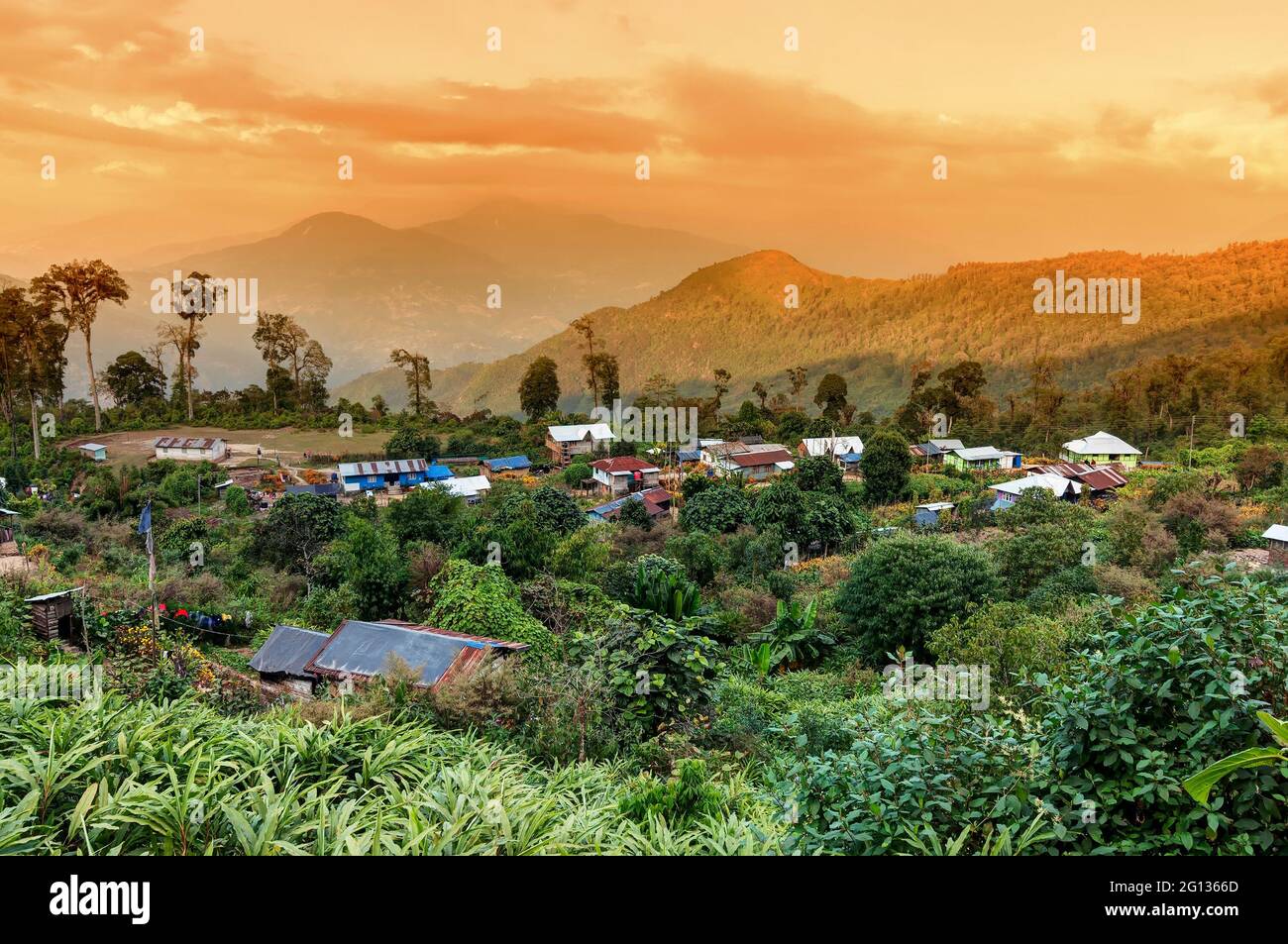 Beautiful view of Silerygaon Village with Kanchenjunga mountain range at the background, at orange colored dusk light, at Sikkim, India Stock Photo