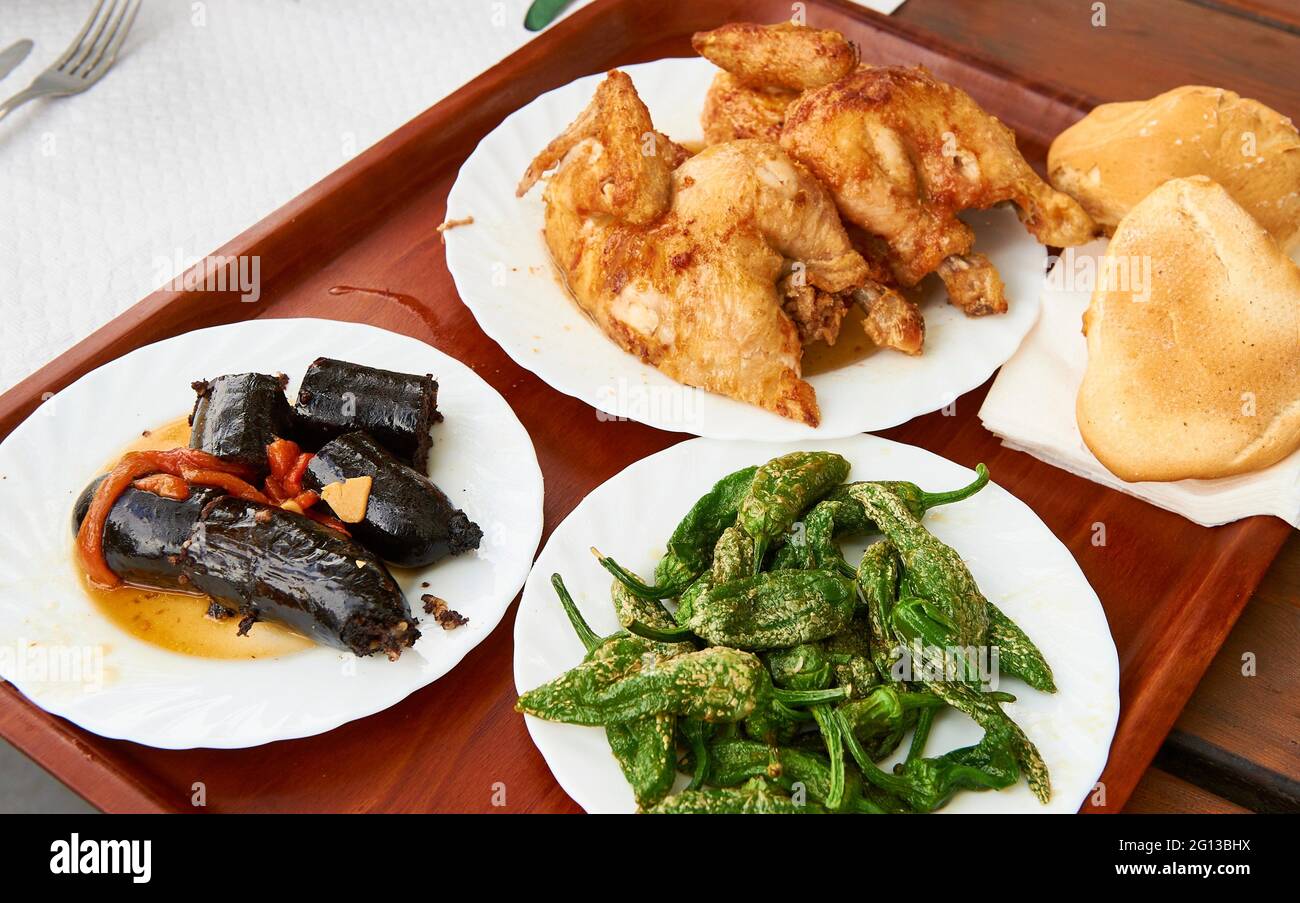 Brewery menu with blood sausage, green peppers and roast chicken. Stock Photo